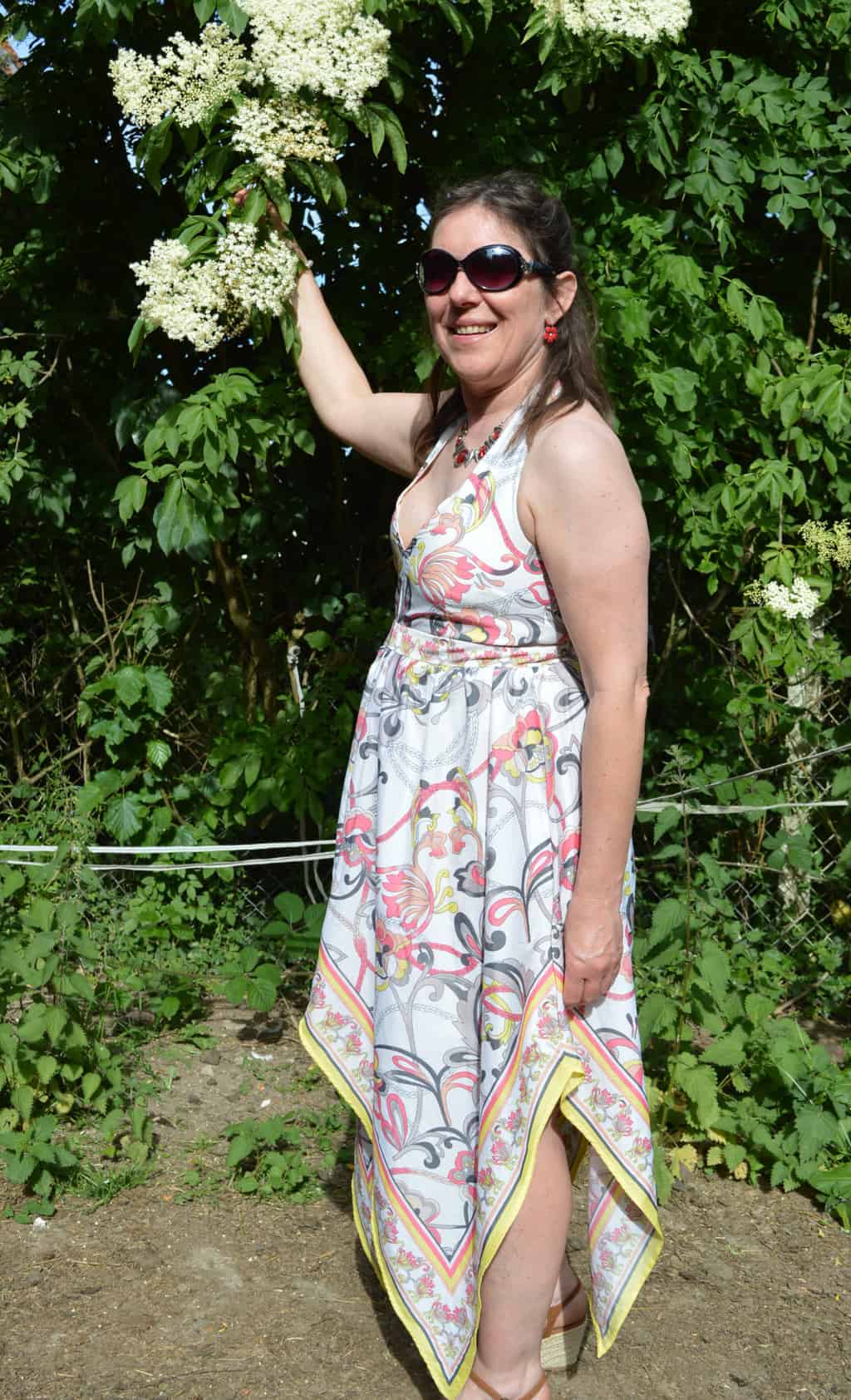 Modèle portant robe foulard devant arbre avec lunettes de soleil